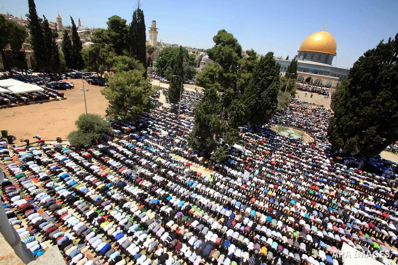 Palestinian Muslim worshippers perform Friday prayer in front of the Dome of the Rock mosque at the al-Aqsa mosque compound in Jerusalem's old city on June 24, 2016 during the holy fasting month of Ramadan. Photo by Mahf...