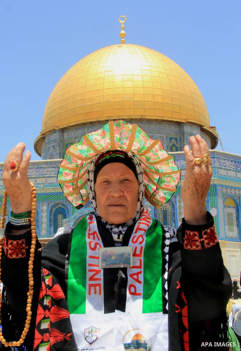 Palestinian Muslim worshippers perform Friday prayer in front of the Dome of the Rock mosque at the al-Aqsa mosque compound in Jerusalem's old city on June 24, 2016 during the holy fasting month of Ramadan. Photo by Mahf...