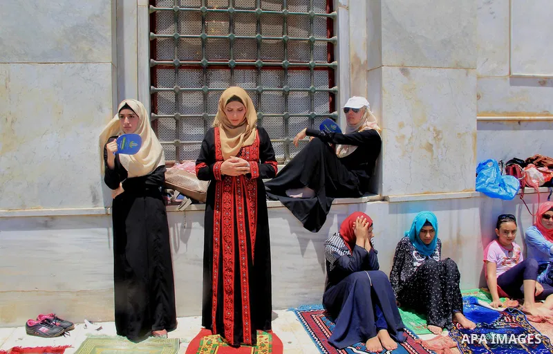 Palestinian Muslim worshippers perform Friday prayer in front of the Dome of the Rock mosque at the al-Aqsa mosque compound in Jerusalem's old city on June 24, 2016 during the holy fasting month of Ramadan. Photo by Mahf...