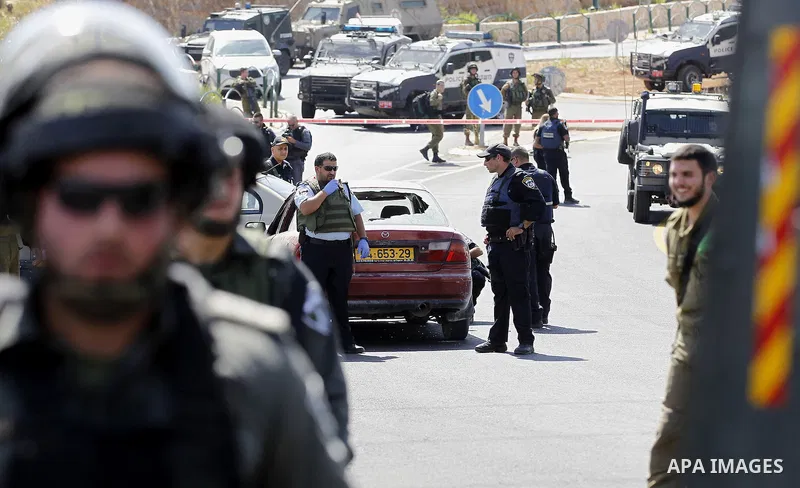 Israeli security forces gather at the scene where a female Palestinian was shot dead by Israeli troops at the entrance to Kiryat Arba near the West Bank city of Hebron June 24, 2016. Photo by Wisam Hashlamoun