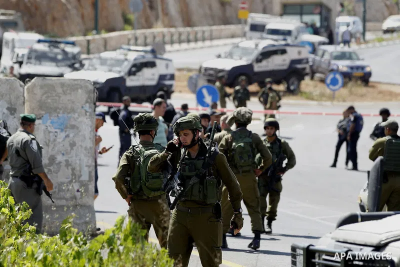 Israeli security forces gather at the scene where a female Palestinian was shot dead by Israeli troops at the entrance to Kiryat Arba near the West Bank city of Hebron June 24, 2016. Photo by Wisam Hashlamoun