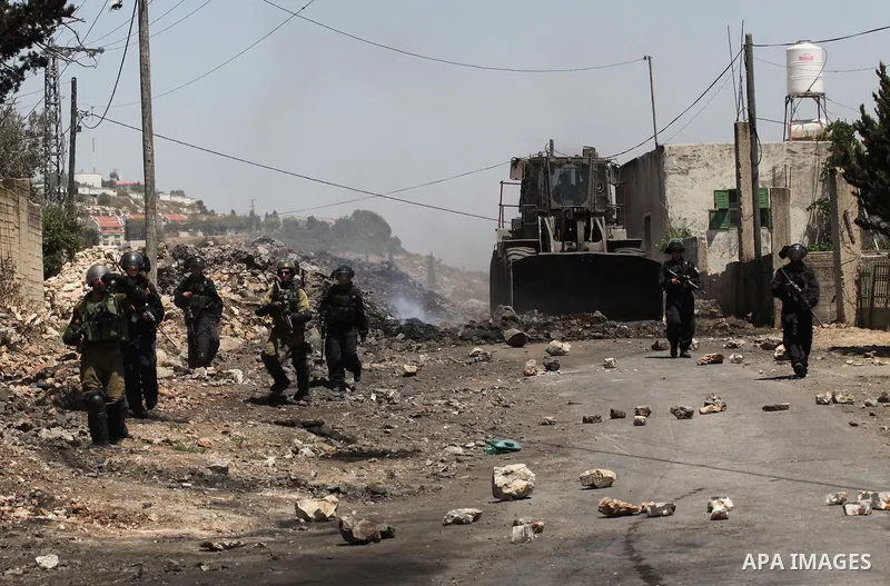 Israeli security forces advance during clashes with Palestinian protesters following a demonstration against the expropriation of Palestinian land by Israel on June 24, 2016 in the village of Kfar Qaddum, near Nablus, in...