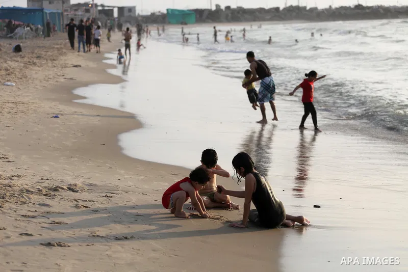 Palestinian children enjoy at the beach of the Mediterranean sea on the coast of Gaza city during a hot day, on June 24, 2016. Photo by Mohammed Asad