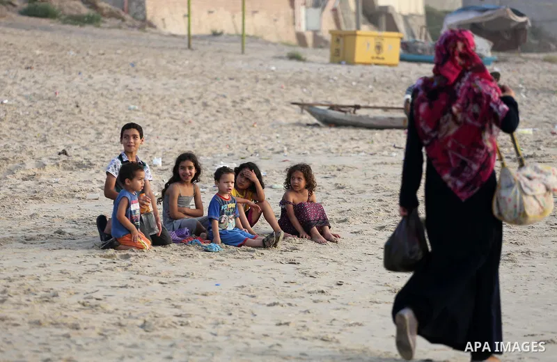 Palestinian children enjoy at the beach of the Mediterranean sea on the coast of Gaza city during a hot day, on June 24, 2016. Photo by Mohammed Asad