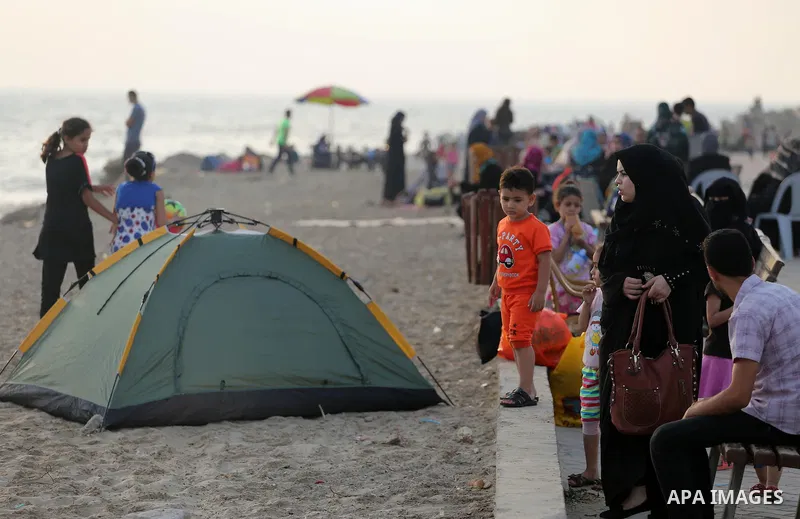 Palestinian muslims prepare to break their fast on the holy fasting month of Ramadan at the beach of the Mediterranean sea on the coast of Gaza city during a hot day, on June 24, 2016. Ramadan is sacred to Muslims becaus...