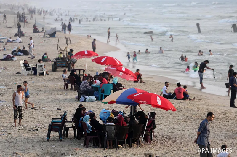 Palestinian muslims prepare to break their fast on the holy fasting month of Ramadan at the beach of the Mediterranean sea on the coast of Gaza city during a hot day, on June 24, 2016. Ramadan is sacred to Muslims becaus...