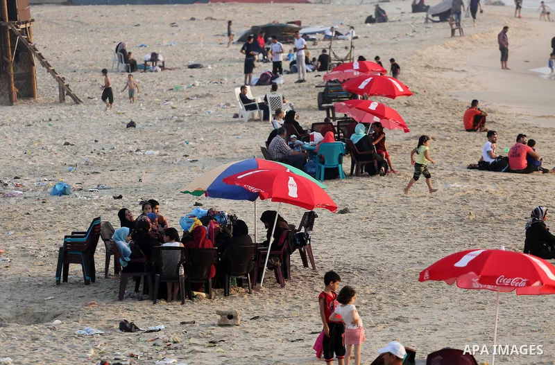 Palestinian muslims prepare to break their fast on the holy fasting month of Ramadan at the beach of the Mediterranean sea on the coast of Gaza city during a hot day, on June 24, 2016. Ramadan is sacred to Muslims becaus...