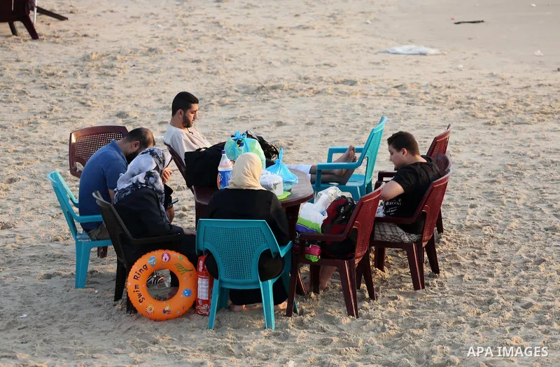 Palestinian muslims prepare to break their fast on the holy fasting month of Ramadan at the beach of the Mediterranean sea on the coast of Gaza city during a hot day, on June 24, 2016. Ramadan is sacred to Muslims becaus...