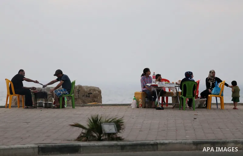Palestinian muslims prepare to break their fast on the holy fasting month of Ramadan at the beach of the Mediterranean sea on the coast of Gaza city during a hot day, on June 24, 2016. Ramadan is sacred to Muslims becaus...