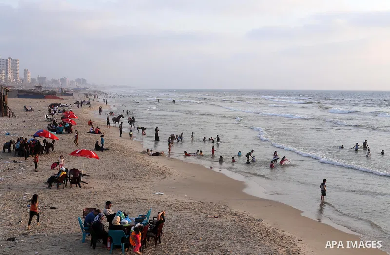 Palestinian muslims prepare to break their fast on the holy fasting month of Ramadan at the beach of the Mediterranean sea on the coast of Gaza city during a hot day, on June 24, 2016. Ramadan is sacred to Muslims becaus...