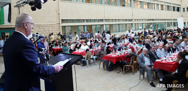 Palestinian Prime Minister Rami Hamdallah takes part during take breakfast for orphans on holy fasting month of Ramadan, at An-Najah national University, in the West Bank City of Nablus, on June 24, 2016. Photo by Prime...