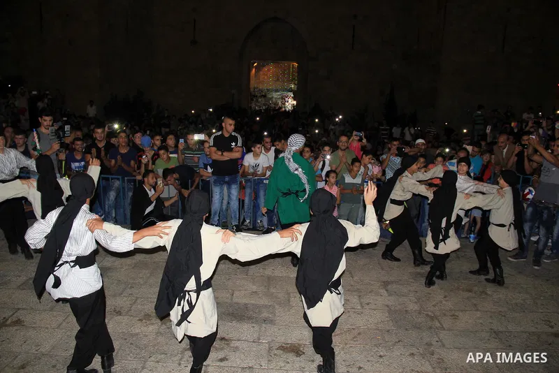 Palestinians youth participate in dancing of "Dabka" during a ceremony in front of Damascus gate in Jerusalem's old city on the holy fasting month of Ramadan, on June 24, 2016. Ramadan is sacred to Muslims because it is...
