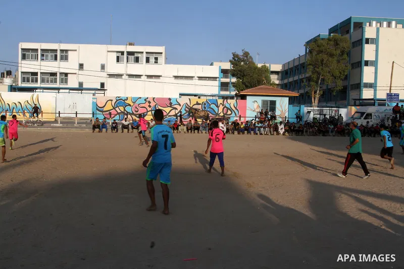 Palestinian youths play football match, at a refugee camp in Rafah, in the southern Gaza Strip, during the Muslim holy month of Ramadan on June 25, 2016. Muslims around the world abstain from food, drink and sexual inter...