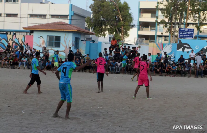 Palestinian youths play football match, at a refugee camp in Rafah, in the southern Gaza Strip, during the Muslim holy month of Ramadan on June 25, 2016. Muslims around the world abstain from food, drink and sexual inter...