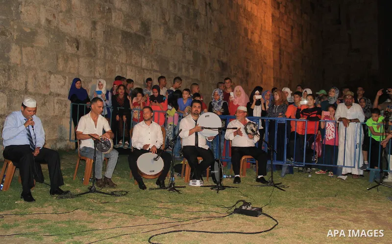Palestinians attend a ceremony in front of Damascus gate in Jerusalem's old city during the holy fasting month of Ramadan on June 25, 2016. Ramadan is sacred to Muslims because it is during that month that tradition says...