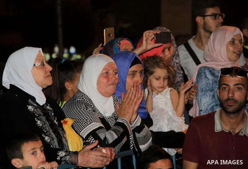 Palestinians attend a ceremony in front of Damascus gate in Jerusalem's old city during the holy fasting month of Ramadan on June 25, 2016. Ramadan is sacred to Muslims because it is during that month that tradition says...