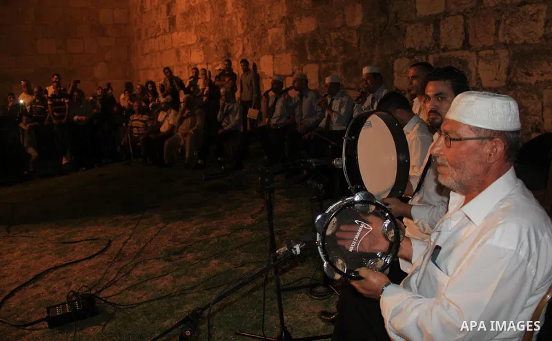 Palestinians attend a ceremony in front of Damascus gate in Jerusalem's old city during the holy fasting month of Ramadan on June 25, 2016. Ramadan is sacred to Muslims because it is during that month that tradition says...