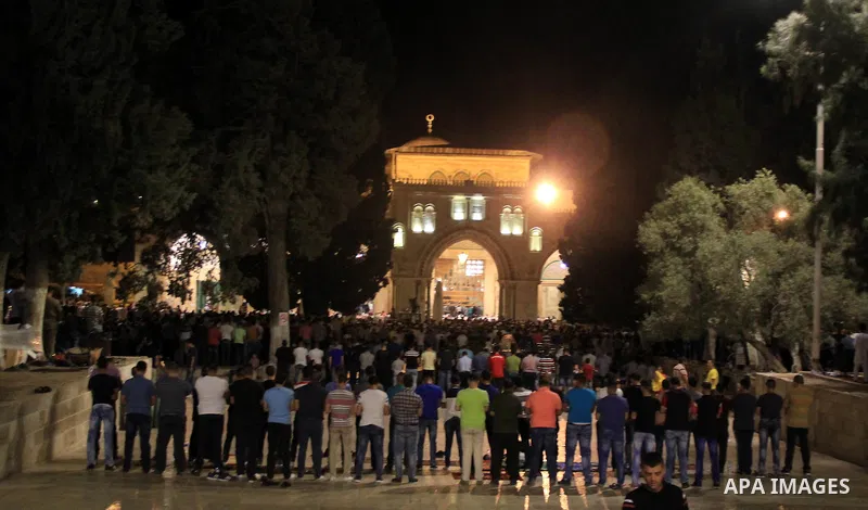 Palestinian Muslim worshippers perform "Taraweeh", nightly prayer of the month of Ramadan, in front of the Dome of the Rock mosque, in Jerusalem's old city on June 25, 2016. Ramadan is sacred to Muslims because it is dur...