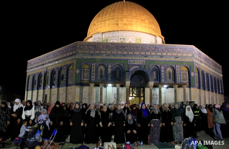 Palestinian Muslim worshippers perform "Taraweeh", nightly prayer of the month of Ramadan, in front of the Dome of the Rock mosque, in Jerusalem's old city on June 25, 2016. Ramadan is sacred to Muslims because it is dur...