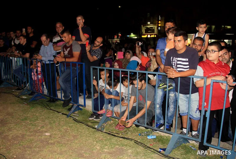 Palestinians attend a ceremony in front of Damascus gate in Jerusalem's old city during the holy fasting month of Ramadan on June 25, 2016. Ramadan is sacred to Muslims because it is during that month that tradition says...