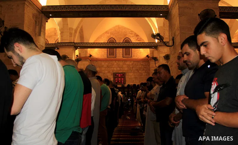 Palestinian Muslim worshippers perform "Taraweeh", nightly prayer of the month of Ramadan, in front of the Dome of the Rock mosque, in Jerusalem's old city on June 25, 2016. Ramadan is sacred to Muslims because it is dur...