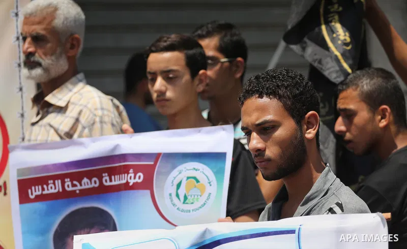 Palestinians take part in a protest demanding release the prisoners in Israeli jails, in Gaza city, on June 26, 2016. Photo by Mohammed Asad