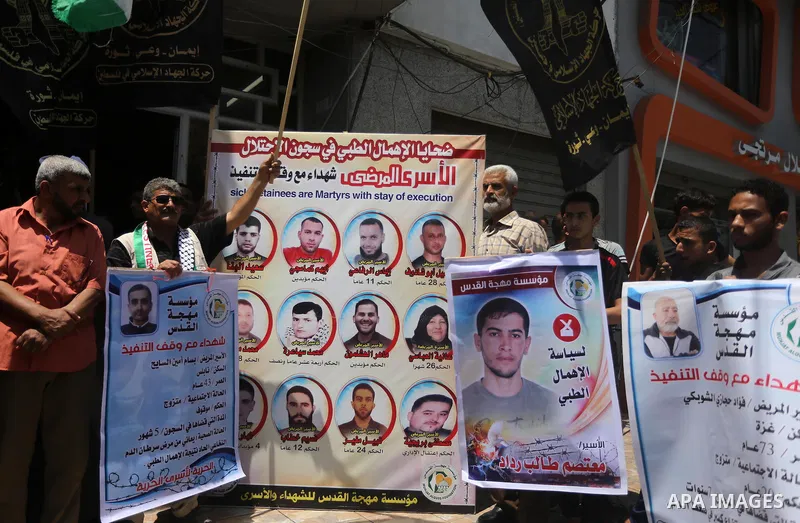 Palestinians take part in a protest demanding release the prisoners in Israeli jails, in Gaza city, on June 26, 2016. Photo by Mohammed Asad