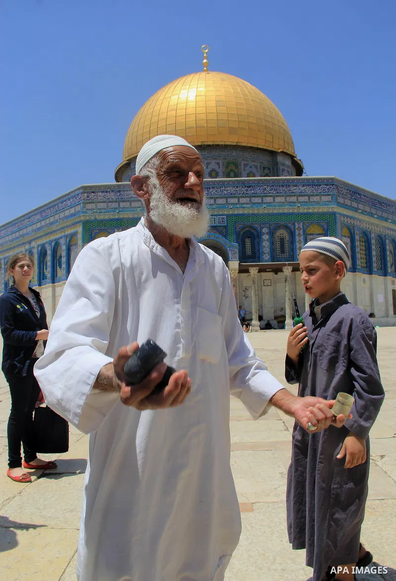 A Palestinian man shows foam-tipped bullets reportedly used by Israeli riot police outside the Dome of the Rock in Jerusalem's Al-Aqsa mosque compound after clashes erupted at the compound between Palestinians and Israel...