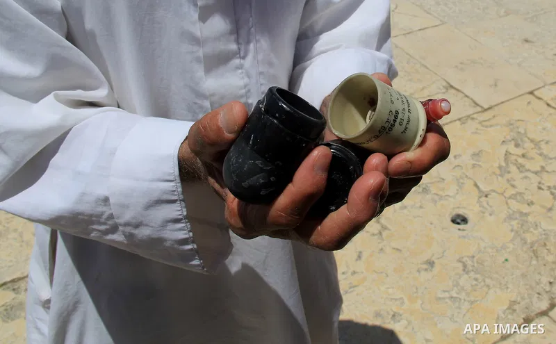 A Palestinian man shows foam-tipped bullets reportedly used by Israeli riot police outside the Dome of the Rock in Jerusalem's Al-Aqsa mosque compound after clashes erupted at the compound between Palestinians and Israel...