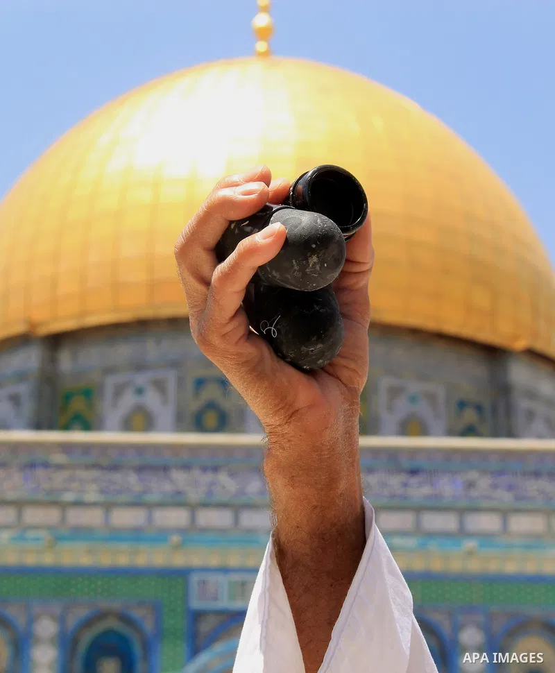 A Palestinian man shows foam-tipped bullets reportedly used by Israeli riot police outside the Dome of the Rock in Jerusalem's Al-Aqsa mosque compound after clashes erupted at the compound between Palestinians and Israel...