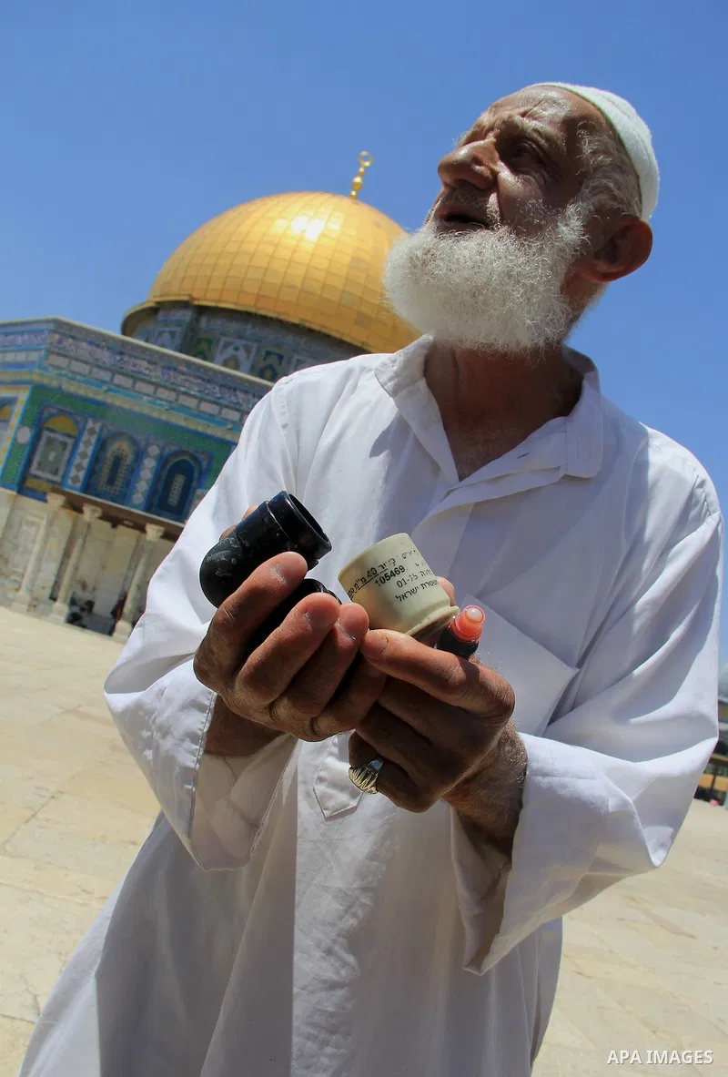 A Palestinian man shows foam-tipped bullets reportedly used by Israeli riot police outside the Dome of the Rock in Jerusalem's Al-Aqsa mosque compound after clashes erupted at the compound between Palestinians and Israel...
