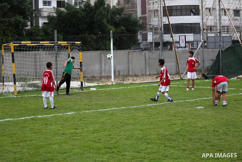 Palestinian orphan children play football match during al-Amal champion in Gaza city, on June 26, 2016 during the Muslim holy month of Ramadan. Ramadan is sacred to Muslims because it is during that month that tradition...