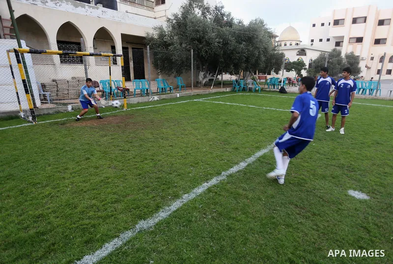 Palestinian orphan children play football match during al-Amal champion in Gaza city, on June 26, 2016 during the Muslim holy month of Ramadan. Ramadan is sacred to Muslims because it is during that month that tradition...