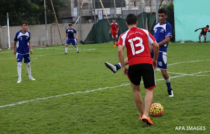 Palestinian orphan children play football match during al-Amal champion in Gaza city, on June 26, 2016 during the Muslim holy month of Ramadan. Ramadan is sacred to Muslims because it is during that month that tradition...
