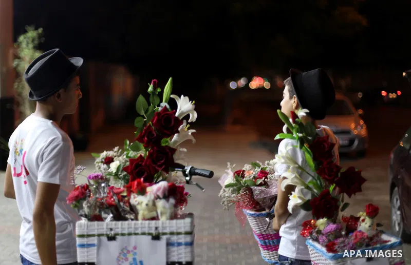 Palestinian youths wander on colorful bicycles and sell flowers at street in Gaza city, on June 26, 2016. Unemployment in the Palestinian enclave of Gaza has risen dramatically to reach around 45 percent, one of the high...