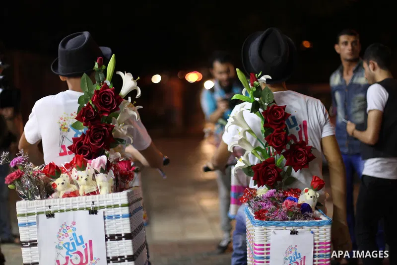Palestinian youths wander on colorful bicycles and sell flowers at street in Gaza city, on June 26, 2016. Unemployment in the Palestinian enclave of Gaza has risen dramatically to reach around 45 percent, one of the high...
