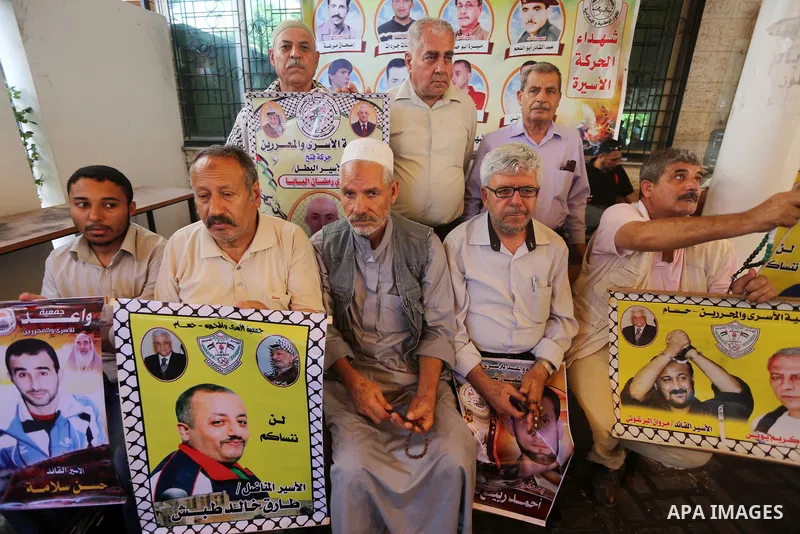 Palestinians take part in a protest demanding release the prisoners in Israeli jails, in front of Red cross office, in Gaza city, on June 27, 2016. Photo by Mohammed Asad