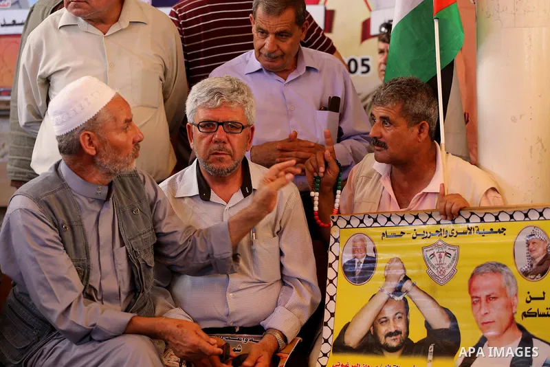 Palestinians take part in a protest demanding release the prisoners in Israeli jails, in front of Red cross office, in Gaza city, on June 27, 2016. Photo by Mohammed Asad