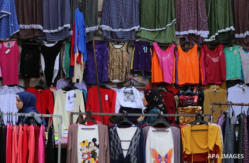 Palestinians shop at clothes market during the Muslim holy month of Ramadan, in Gaza city on June 27, 2016. Ramadan is sacred to Muslims because it is during that month that tradition says the Koran was revealed to the P...