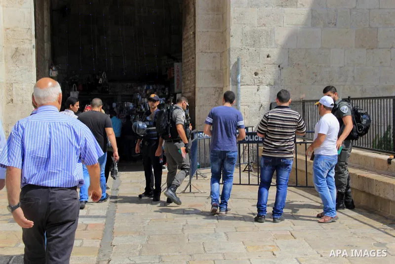 Palestinian men walk outside Jerusalem's al-Aqsa mosque after clashes erupted at the compound between Palestinians and Israeli police, on June 28, 2016. An Israeli police spokesman said on Tuesday that the compound would...