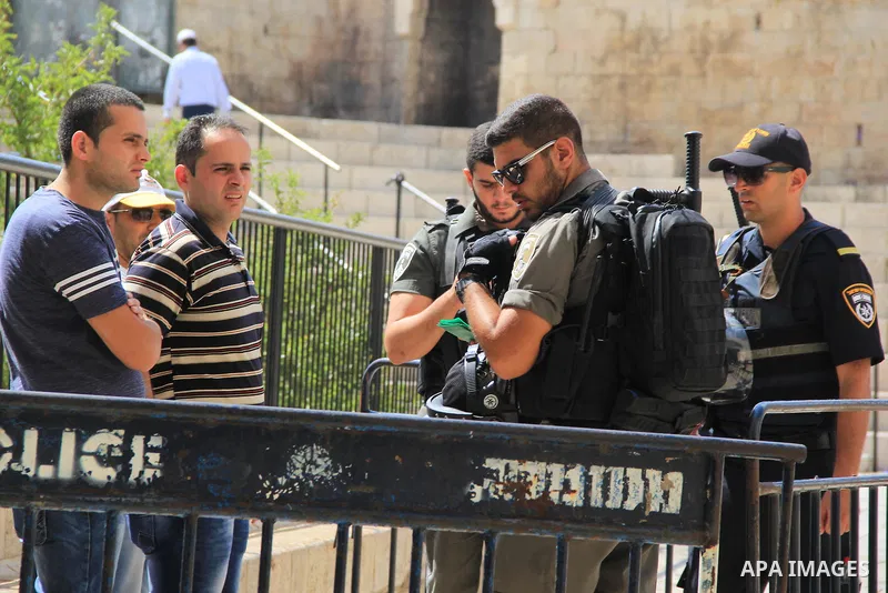 Israeli policemen checks the IDs of Palestinian youths at Al-Aqsa Mosque compound in Jerusalem's old city, on June 28, 2016. An Israeli police spokesman said on Tuesday that the compound would be closed to visitors, incl...