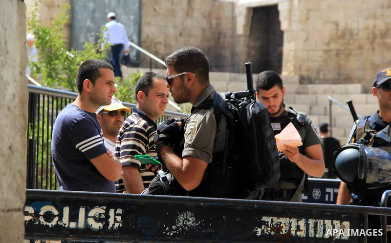 Israeli policemen checks the IDs of Palestinian youths at Al-Aqsa Mosque compound in Jerusalem's old city, on June 28, 2016. An Israeli police spokesman said on Tuesday that the compound would be closed to visitors, incl...