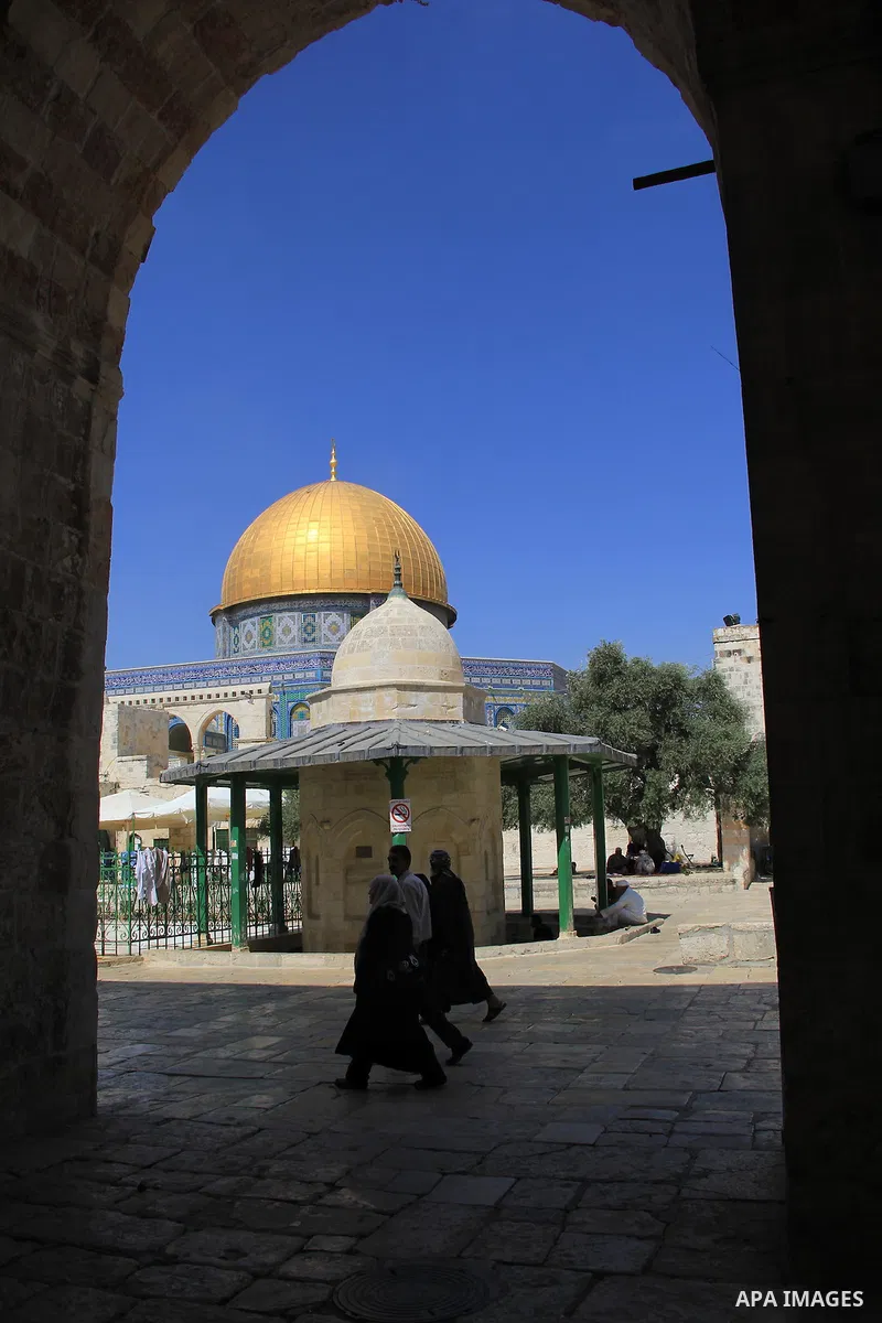 Palestinian men walk outside Jerusalem's al-Aqsa mosque after clashes erupted at the compound between Palestinians and Israeli police, on June 28, 2016. An Israeli police spokesman said on Tuesday that the compound would...