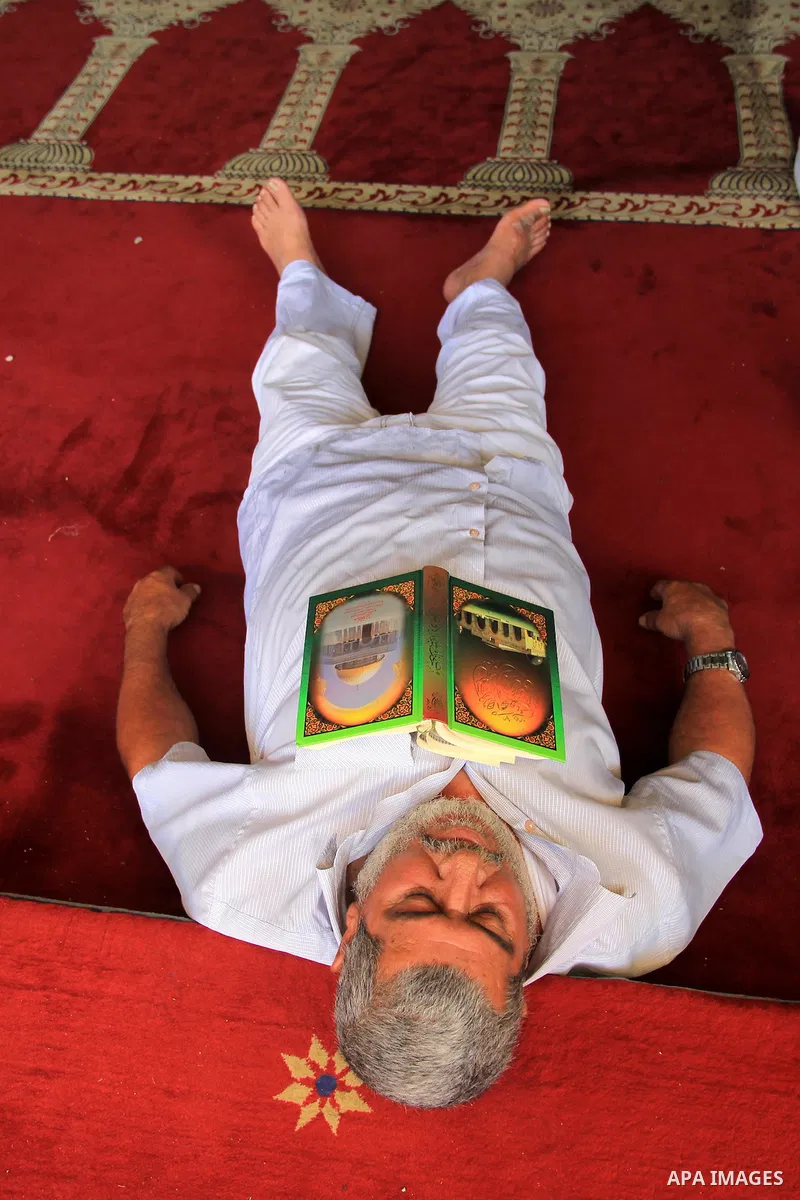 A Palestinian Muslim worshipper sleeps at al-Aqsa mosque, in Jerusalem's old city, on June 28, 2016. An Israeli police spokesman said on Tuesday that the compound would be closed to visitors, including Jewish visitors, f...