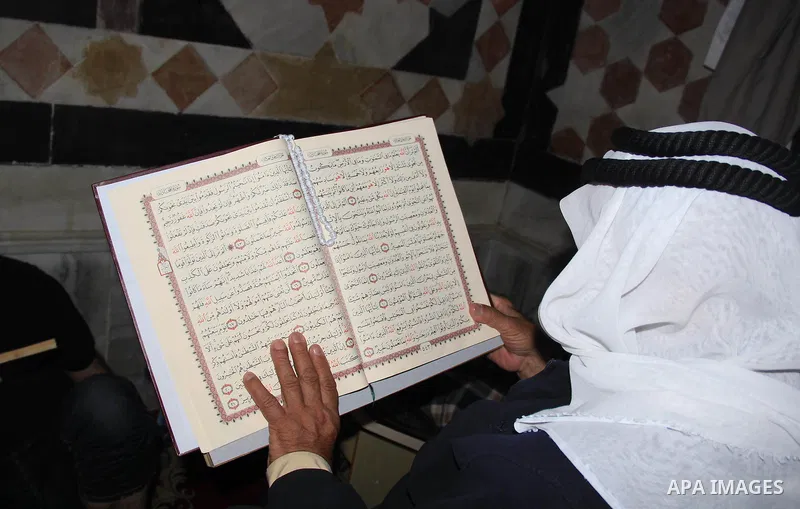 Palestinian men read the Koran, Islam's holy book, at al-Aqsa mosque during the holy month of Ramadan, in Jerusalem's old city, on June 28, 2016. An Israeli police spokesman said on Tuesday that the compound would be clo...