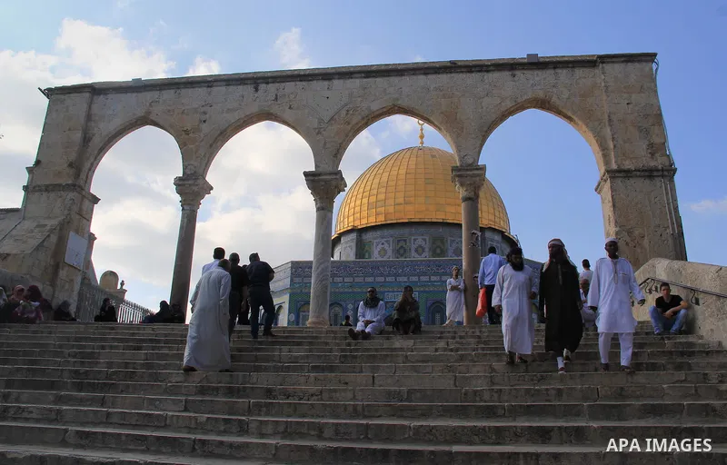 Palestinian men walk outside Jerusalem's al-Aqsa mosque after clashes erupted at the compound between Palestinians and Israeli police, on June 28, 2016. An Israeli police spokesman said on Tuesday that the compound would...