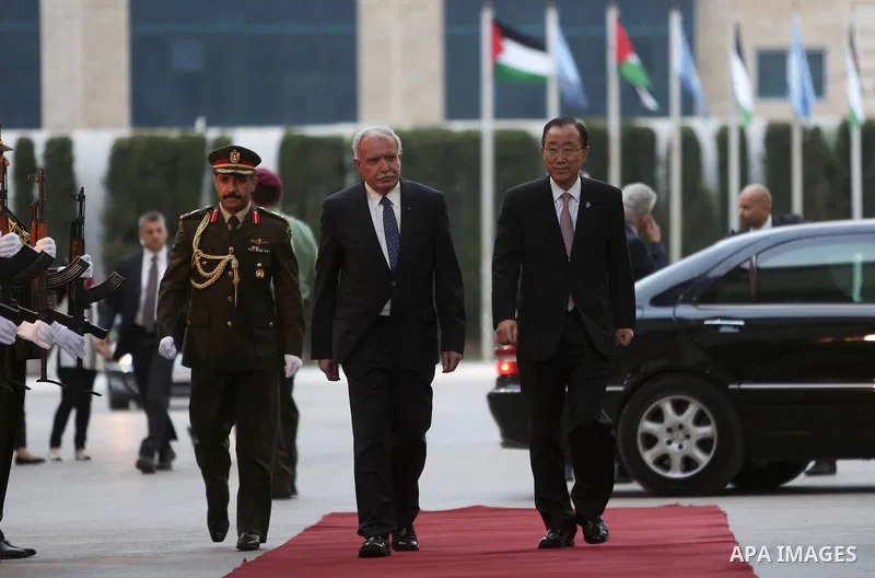 United Nations Secretary General Ban Ki-moon walks alongside Palestinian foreign minister Riyad al-Malki as he arrives at the Muqataa, the Palestinian Authority headquarters, in the West Bank city of Ramallah, on June 28...