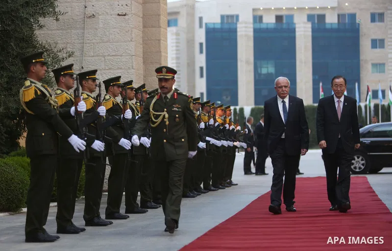 United Nations Secretary General Ban Ki-moon walks alongside Palestinian foreign minister Riyad al-Malki as he arrives at the Muqataa, the Palestinian Authority headquarters, in the West Bank city of Ramallah, on June 28...