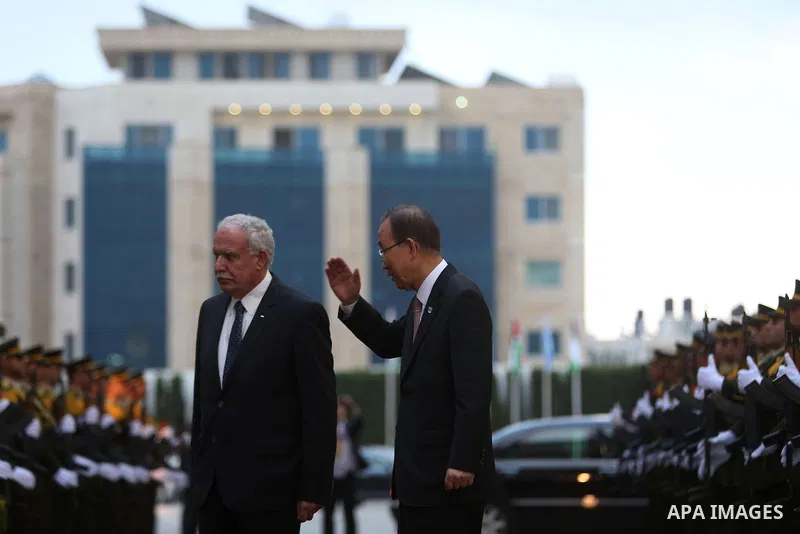 United Nations Secretary General Ban Ki-moon walks alongside Palestinian foreign minister Riyad al-Malki as he arrives at the Muqataa, the Palestinian Authority headquarters, in the West Bank city of Ramallah, on June 28...
