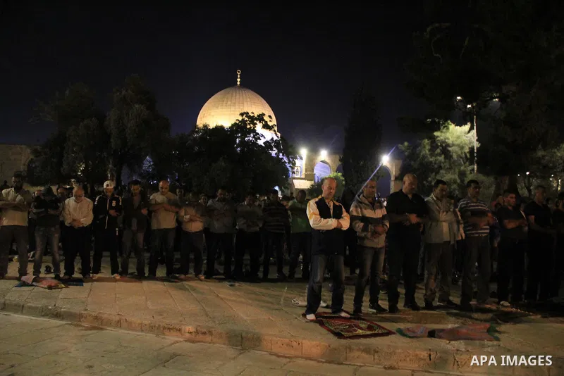 Palestinian Muslim worshippers perform "Taraweeh", nightly prayer of the month of Ramadan, in front of the Dome of the Rock mosque, in Jerusalem's old city on June 28, 2016. Ramadan is sacred to Muslims because it is dur...